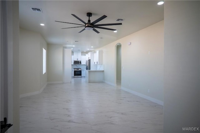 unfurnished living room with marble finish floor, baseboards, and visible vents