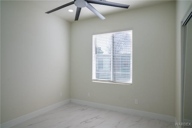 unfurnished room with marble finish floor, baseboards, a ceiling fan, and recessed lighting