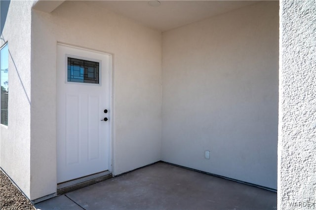 view of exterior entry with stucco siding