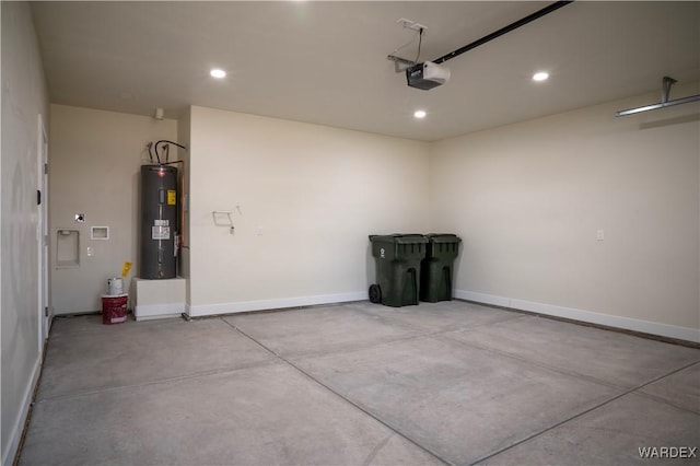 garage with a garage door opener, recessed lighting, electric water heater, and baseboards