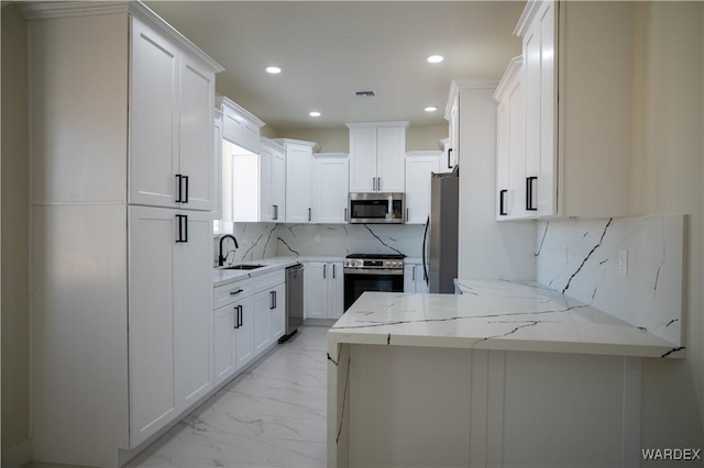 kitchen featuring marble finish floor, visible vents, appliances with stainless steel finishes, white cabinetry, and light stone countertops