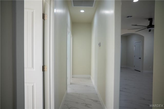 hall featuring arched walkways, marble finish floor, recessed lighting, visible vents, and baseboards