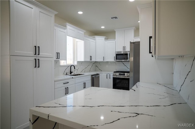 kitchen featuring white cabinetry and appliances with stainless steel finishes