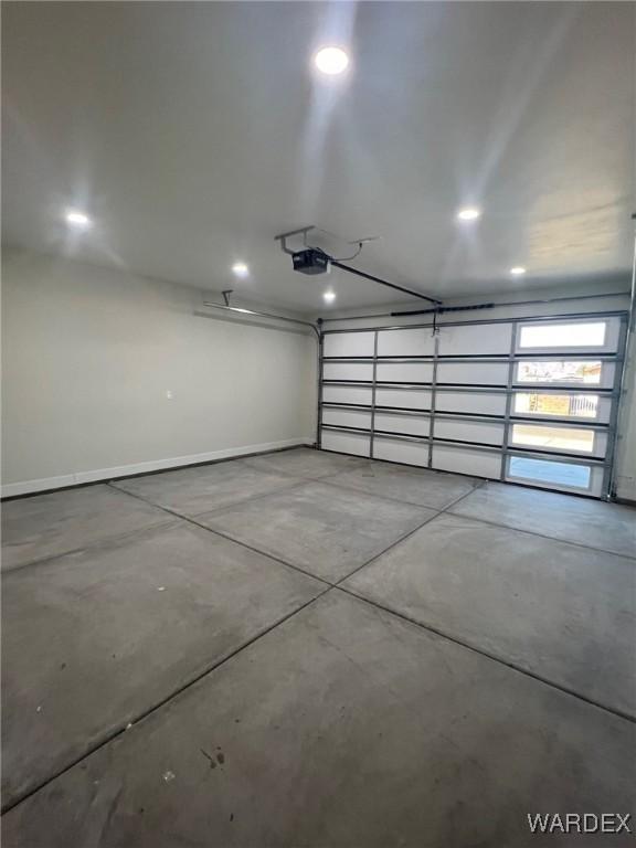 garage featuring baseboards and a garage door opener