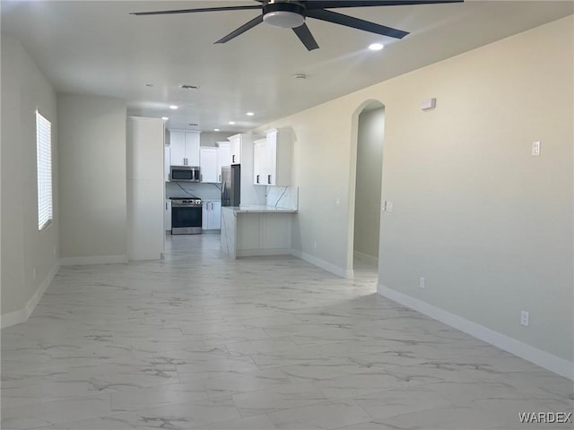 unfurnished living room with arched walkways, recessed lighting, visible vents, baseboards, and marble finish floor