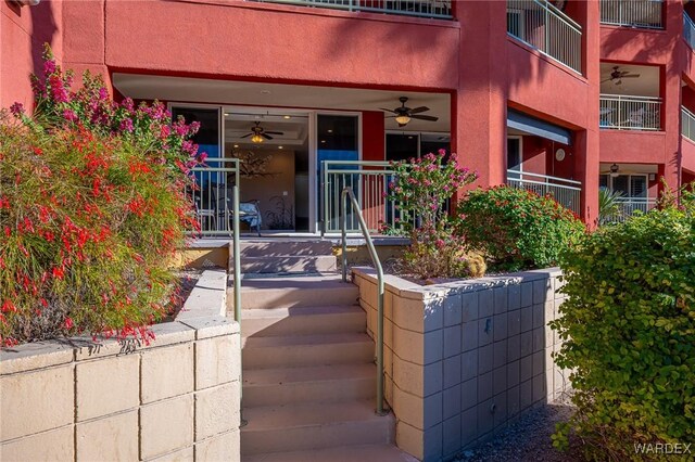 entrance to property featuring stucco siding