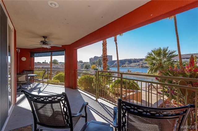 balcony with a ceiling fan and a water view