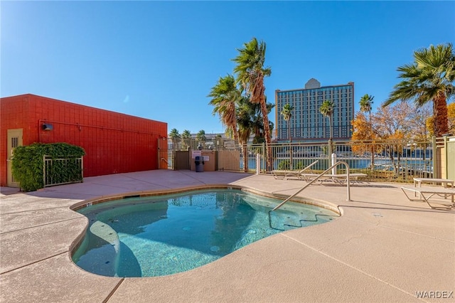 community pool featuring a patio area and fence