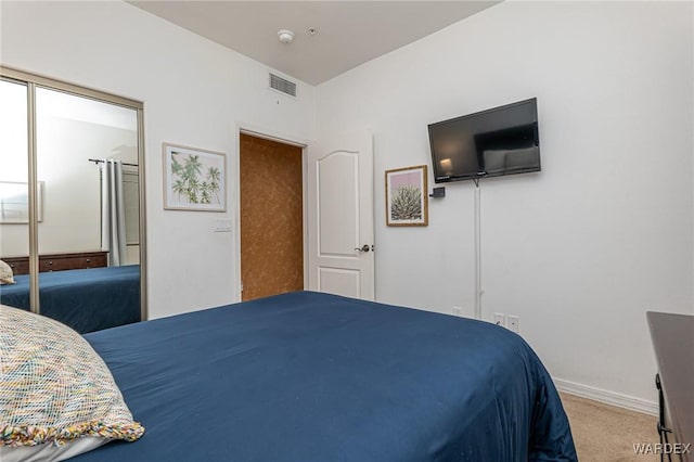 bedroom featuring carpet floors, visible vents, and baseboards