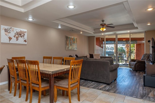 dining room featuring ceiling fan, a tray ceiling, baseboards, and recessed lighting