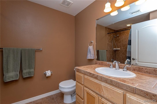 full bath featuring toilet, vanity, visible vents, and tile patterned floors