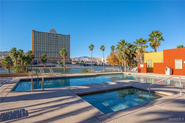 pool featuring fence, a mountain view, and a patio