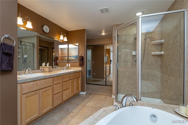 bathroom featuring a stall shower, tile patterned flooring, and a sink