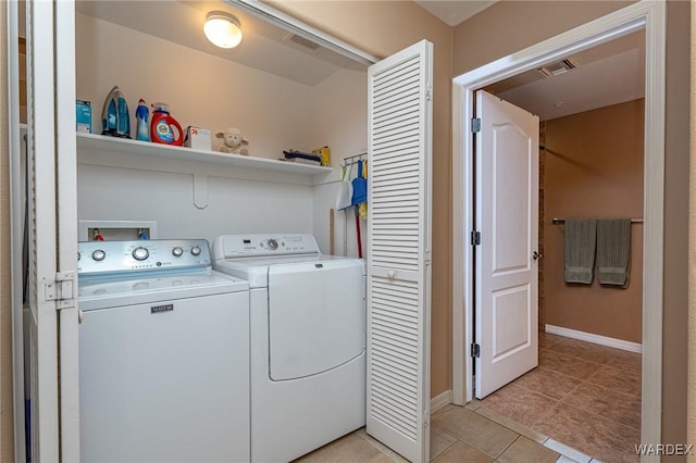 laundry area featuring laundry area, visible vents, washing machine and clothes dryer, and light tile patterned floors