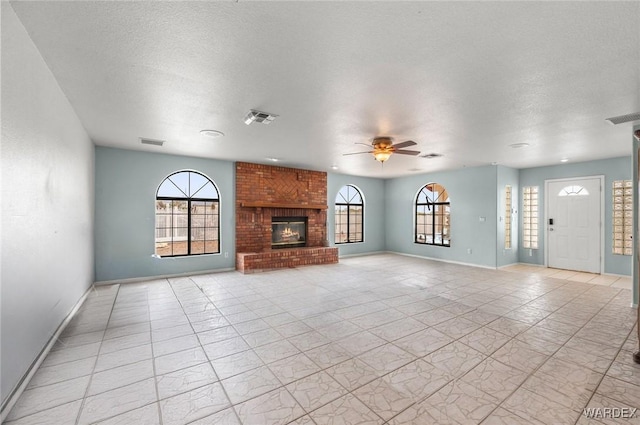4393 S Colorado Rd, Fort Mohave, AZ 86426 - unfurnished living room featuring a ceiling fan, baseboards, visible vents, and a fireplace