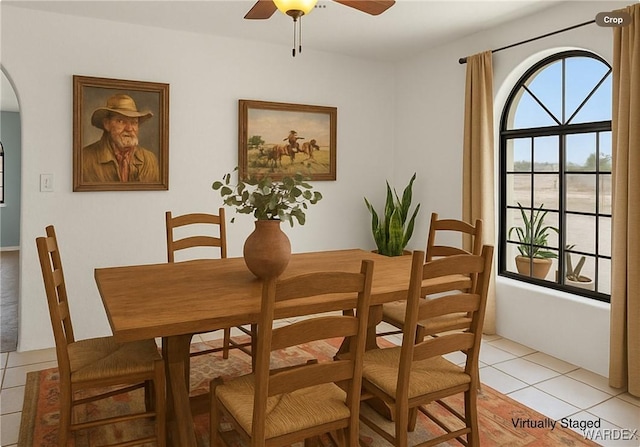 4393 S Colorado Rd, Fort Mohave, AZ 86426 - dining room featuring arched walkways, a ceiling fan, and light tile patterned floors