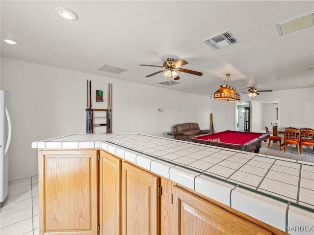 4393 S Colorado Rd, Fort Mohave, AZ 86426 - kitchen featuring tile counters, open floor plan, ceiling fan, and visible vents
