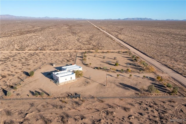 birds eye view of property with a rural view, a mountain view, and view of desert