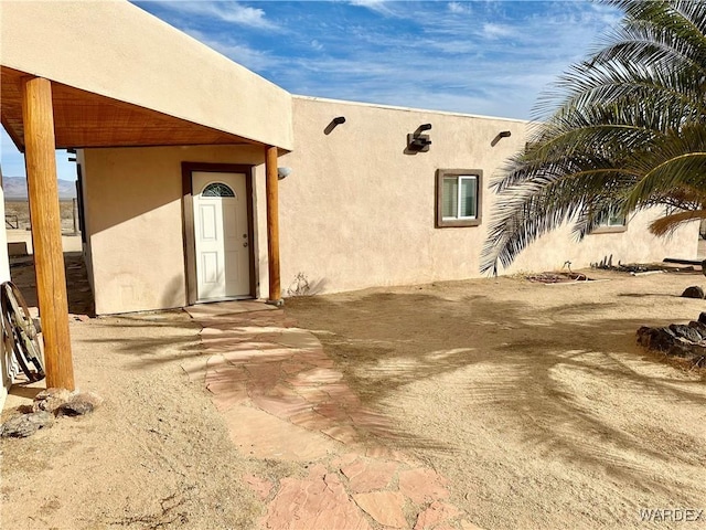 rear view of property with stucco siding