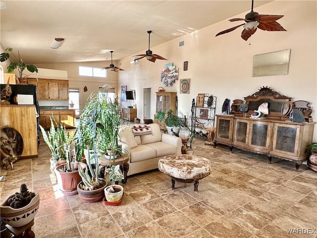 living room with visible vents, high vaulted ceiling, and a ceiling fan