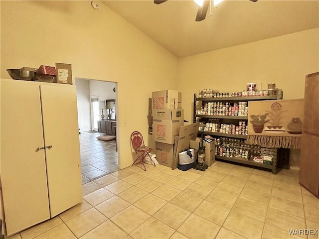 interior space with high vaulted ceiling, a ceiling fan, and light tile patterned flooring