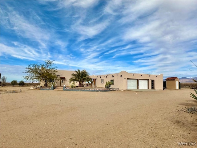 view of front of house with driveway and stucco siding