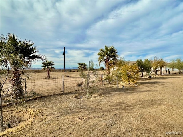 view of yard featuring a rural view and fence