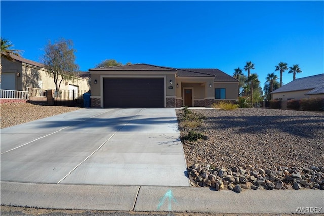 view of front facade featuring stucco siding, concrete driveway, fence, a garage, and stone siding