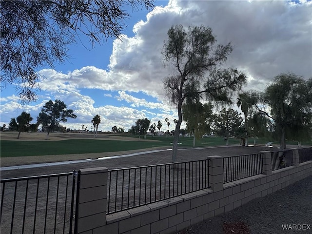 view of community with fence and golf course view