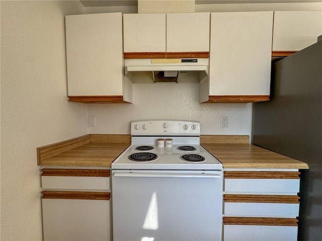 1189 Juanita Ln, Bullhead City, AZ 86442 - kitchen with electric range, under cabinet range hood, freestanding refrigerator, light countertops, and white cabinetry