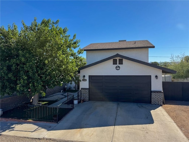 1189 Juanita Ln, Bullhead City, AZ 86442 - view of front of property with stucco siding, driveway, brick siding, and an attached garage