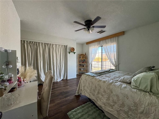 1189 Juanita Ln, Bullhead City, AZ 86442 - bedroom with a textured ceiling, dark wood-type flooring, and ceiling fan