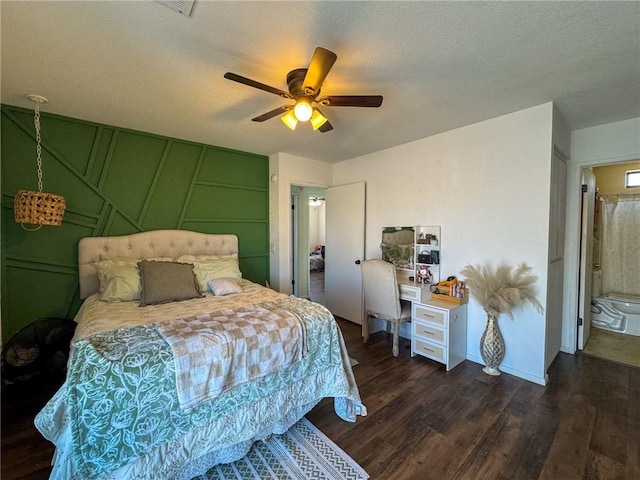 1189 Juanita Ln, Bullhead City, AZ 86442 - bedroom with dark wood-style floors, a decorative wall, ceiling fan, and ensuite bathroom