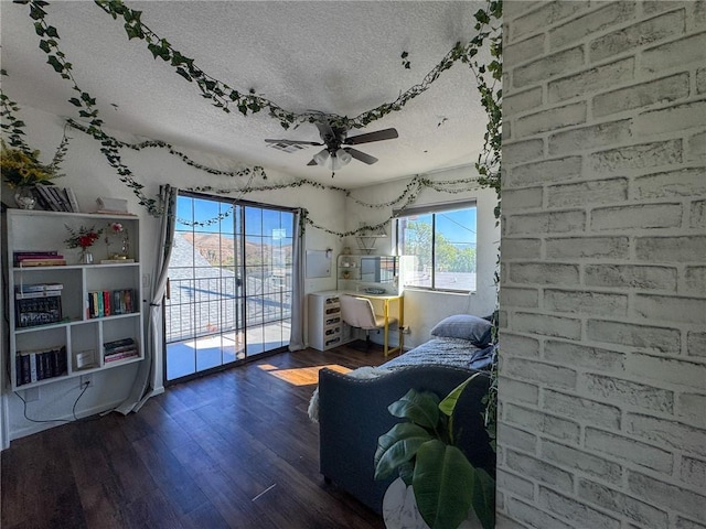 1189 Juanita Ln, Bullhead City, AZ 86442 - bedroom featuring a textured ceiling, access to exterior, wood finished floors, and a ceiling fan