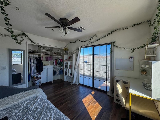 1189 Juanita Ln, Bullhead City, AZ 86442 - bedroom featuring wood finished floors, a textured ceiling, multiple windows, a closet, and a ceiling fan
