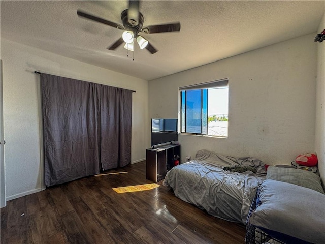 1189 Juanita Ln, Bullhead City, AZ 86442 - bedroom with wood finished floors, a textured ceiling, and ceiling fan