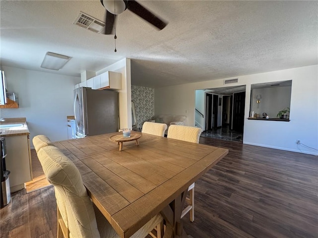 1189 Juanita Ln, Bullhead City, AZ 86442 - dining room featuring wood finished floors, a ceiling fan, and a textured ceiling