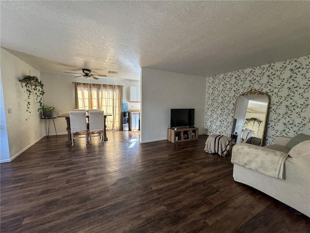 1189 Juanita Ln, Bullhead City, AZ 86442 - living room featuring a textured ceiling, ceiling fan, wood finished floors, arched walkways, and wallpapered walls