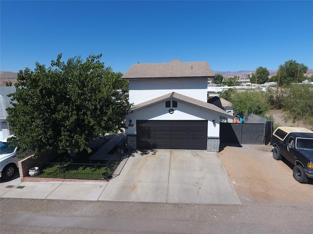 1189 Juanita Ln, Bullhead City, AZ 86442 - view of front of property featuring driveway, an attached garage, and stucco siding