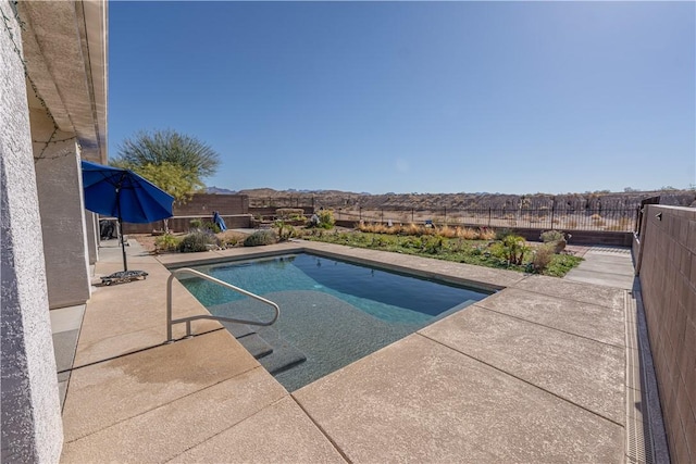 view of pool with a fenced backyard and a patio area
