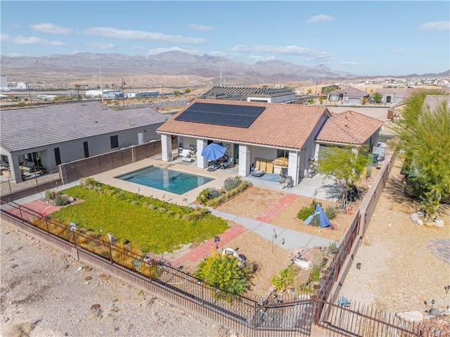 aerial view of property and surrounding area featuring a mountainous background and a pool