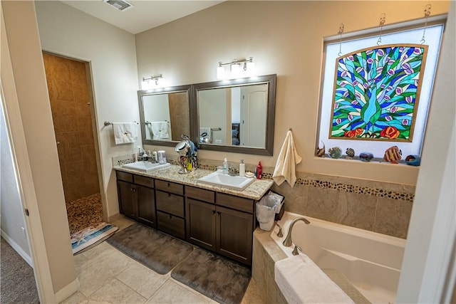 full bathroom with tile patterned floors, a bath, double vanity, and tiled shower
