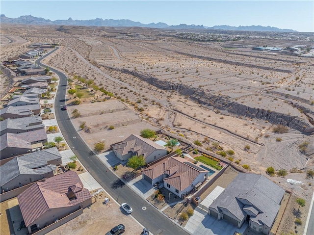 aerial view of residential area with a mountainous background and a desert landscape