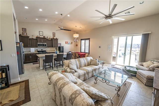 living area with ceiling fan, vaulted ceiling, light tile patterned floors, recessed lighting, and baseboards