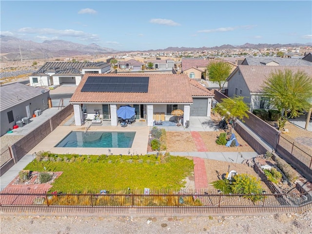 aerial perspective of suburban area with a mountain backdrop and a pool area