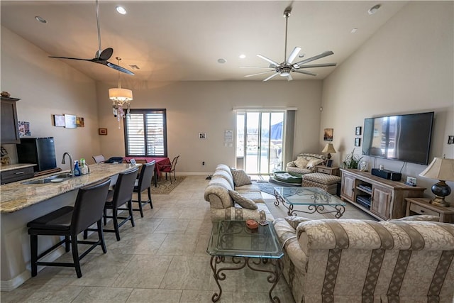 living room with a ceiling fan, lofted ceiling, baseboards, and recessed lighting