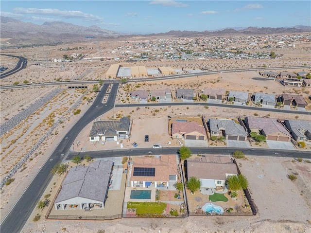aerial view of property's location featuring mountains and nearby suburban area