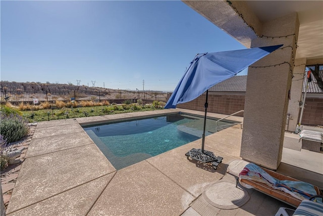 view of swimming pool featuring a fenced backyard and a patio