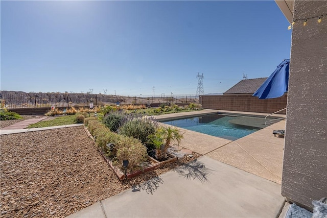 view of pool featuring a fenced backyard and a patio