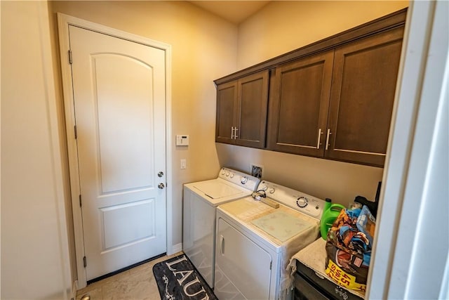 laundry room with cabinet space, independent washer and dryer, and baseboards